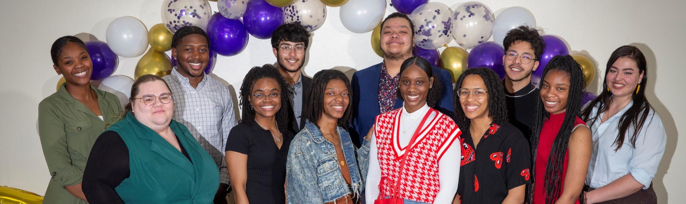 A group of people smile at the camera.