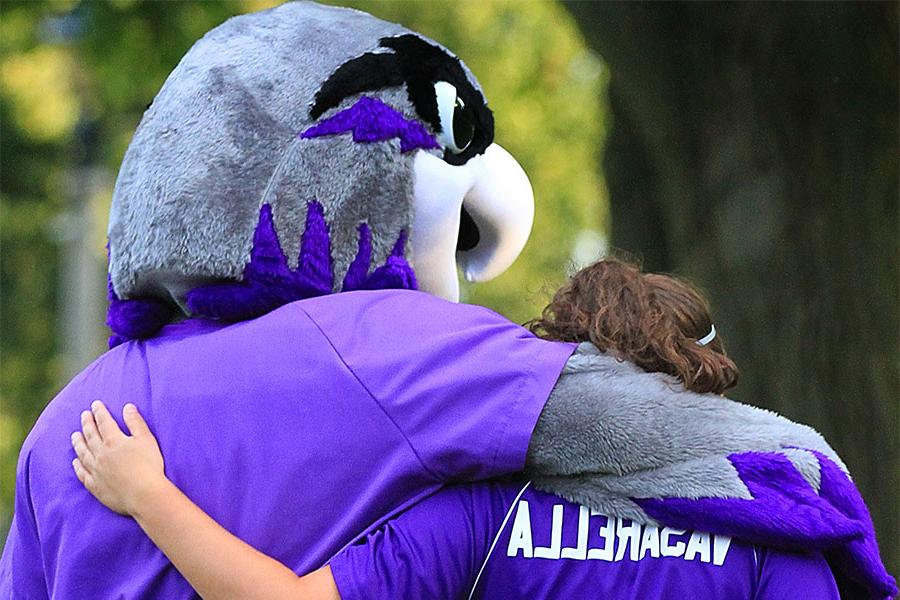 Willie and student embrace in a hug.